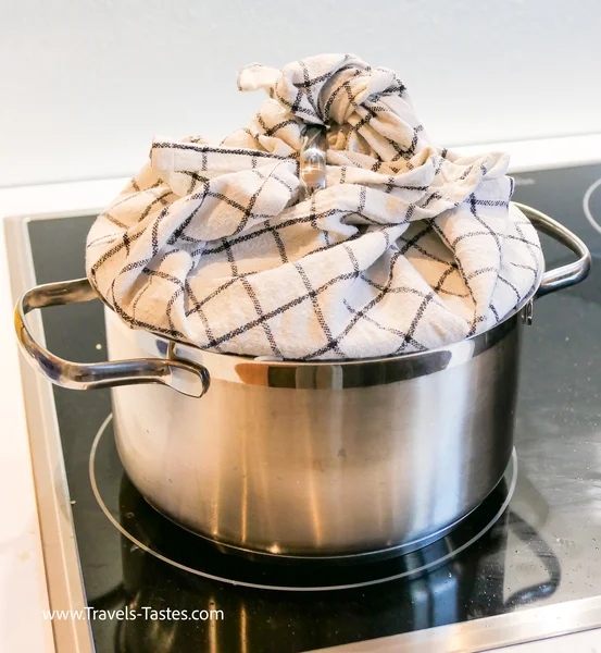 Steaming rice with cloth covered lid